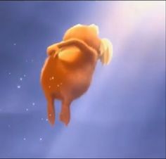 an orange flying through the air in front of a blue sky with stars and clouds