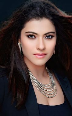 an image of a woman with long hair and jewelry on her neck, posing for the camera