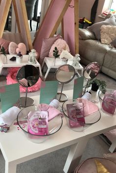 a table topped with lots of pink and white items on top of it's sides
