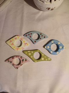 four pieces of wood sitting on top of a white cloth covered table next to a helmet