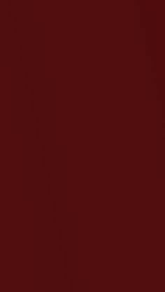 a red wall with a clock on it