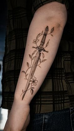 a tattoo on the arm of a person with a knife in it's hand