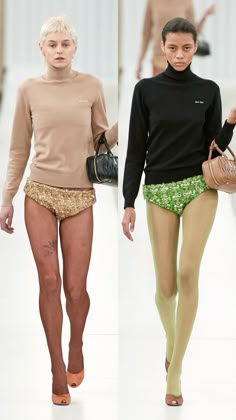 two models walking down the runway in short shorts