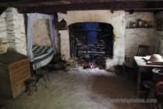 an old fashioned fireplace in a stone walled room