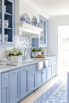 a kitchen with blue cabinets and white counter tops