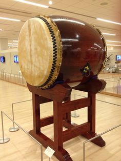 a large drum sitting on top of a wooden stand