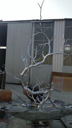 a metal sculpture sitting on top of a table in the middle of a building under construction