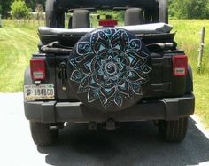 the back end of a jeep with an intricate design on it
