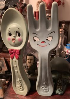 two plastic spoons with cartoon faces on them