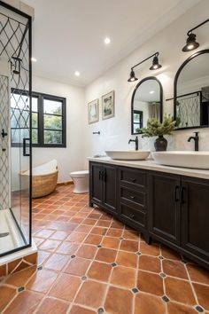 a large bathroom with two sinks and a walk in shower