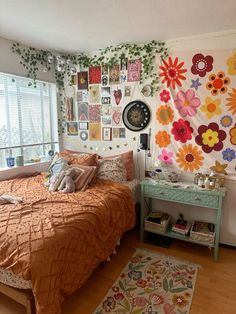 a bed room with a neatly made bed and lots of pictures hanging on the wall