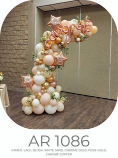 an arch with balloons and stars on it in the shape of a number one is shown