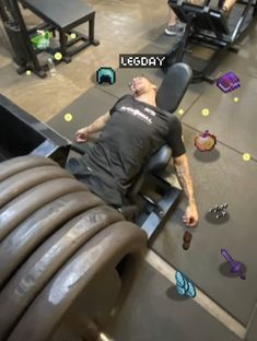 a man laying on top of a bench in a gym