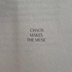 the words chaos makes the muse written in black ink on a white paper sheeted surface
