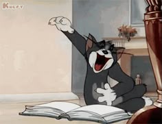 a cartoon cat sitting on the floor with an open book in front of it and its mouth wide open