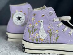 Lilac Goose Converse, Hand Stitched Floral High Tops, Custom Cottagecore Sneakers, Personalized Gift for Women  CONVERSE ∙ EMBROIDERED ∙ GOOSE * Material: High-quality premium cotton embroidery thread, colorfast * Dimensions: Tailored to your selected US shoe size * Finish: High-end embroidery ∙ Sharp threading ∙ Colorfast * All shoes are custom-made by hand with Love and Care in our workshop ♡ 🎁 UNIQUE POINTS 🎁 Includes 1 pair of socks Free custom name or personal information Bright, colorfast embroidery thread, meticulously stitched OUR RETURNS AND REFUND POLICY We take full responsibility for any errors in design or execution on our part. If you wish to return your order for personal reasons, please note that you will need to cover the shipping cost. ADDITIONAL INFORMATION The shoes a Cute Converse Shoes, Converse Embroidery, Cute Converse, Animal Shoes, Embroidered Converse, Kawaii Shoes, Embroidery Shoes, Cute Sneakers, Embroidered Shoes