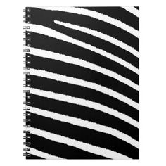 a spiral notebook with black and white stripes