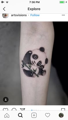 a small panda bear tattoo on the arm