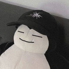 a black and white stuffed animal wearing a hat