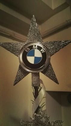 a silver star with a bmw emblem on it's centerpiece in a room
