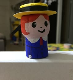 a plastic cup with a little red headed girl wearing a hat on top of it