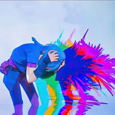 a woman is bending over with colorful paint on her face and arms, in front of a white background