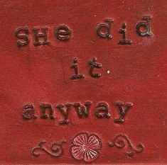 a red sign that says she did it anyway