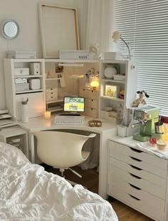 a bedroom with white furniture and lots of drawers