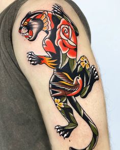 a man with a tattoo on his arm that has a lizard and roses on it