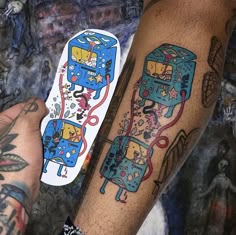two people with tattoos on their arms holding wii controllers and remotes next to each other