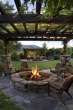 an outdoor fire pit with chairs around it
