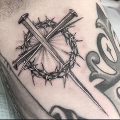 a cross and crown tattoo on the chest with barbed wire around it's edges