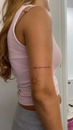a woman with a small tattoo on her left arm and the words, she cannot't stop