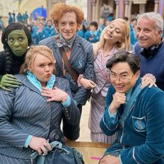 several people dressed in costumes posing for a photo