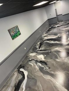 the floor is covered in metallic paint and has a painting hanging on it's wall