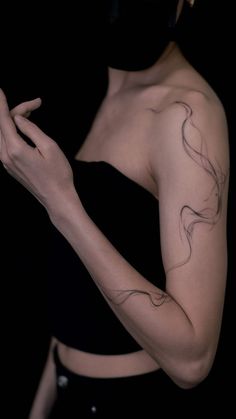 a woman wearing a black top and holding her hands together