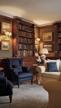 a living room filled with furniture and bookshelves