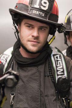a man wearing a fireman's uniform and helmet with the number 19 on it