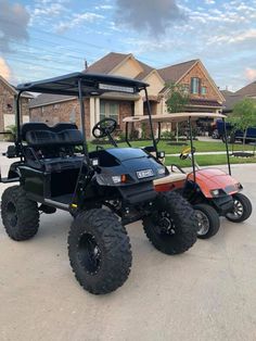 a golf cart parked in front of a house with two carts attached to the back