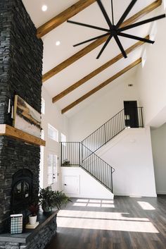 a living room filled with furniture and a fire place in the middle of a room