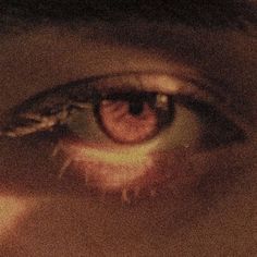 an extreme close up shot of someone's eye with the reflection of another person