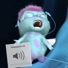 a stuffed animal with pink hair and headphones holding a sign that says headphones
