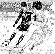 two men are playing soccer in front of an audience