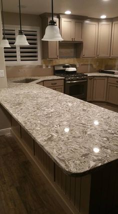 a kitchen with an island counter top in the middle