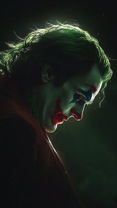 the joker is looking down at his face