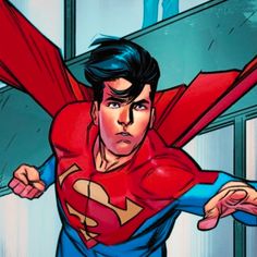 a man in a superman suit with his arms outstretched