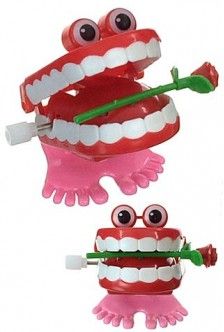 two toothbrushes with eyes and teeth on them, one holding a toothbrush