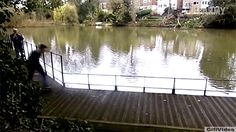 two people walking across a bridge over a body of water