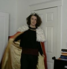 a man dressed in costume standing next to a door with his hands on his hips