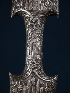 an ornate metal object on a black background
